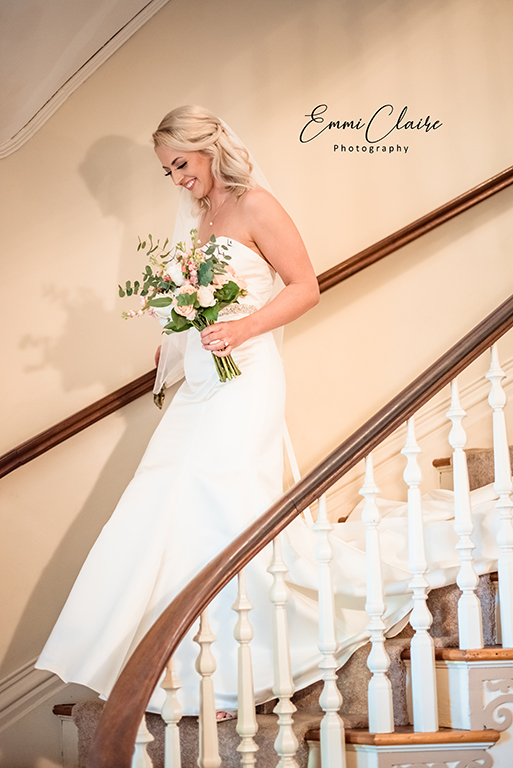 The bride descends the stairs at the Mayhurst Inn.