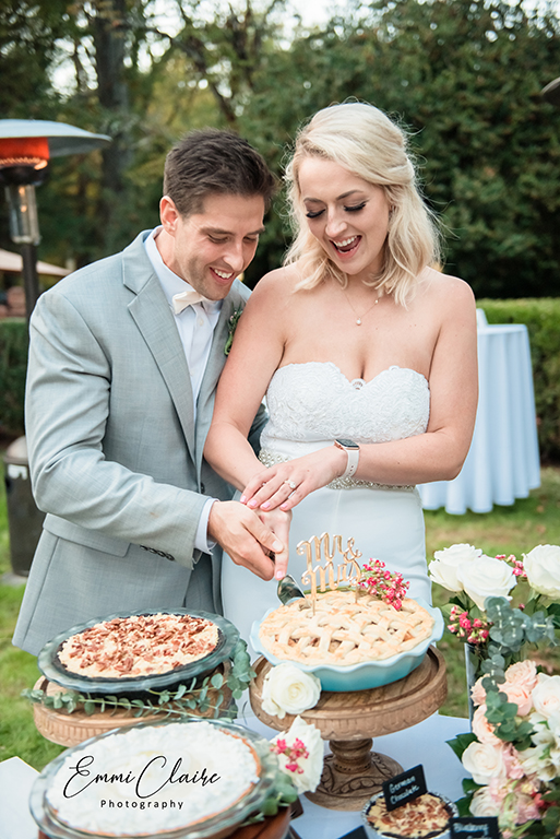 Bride and groom cutting the wedding pie. (Image by EmmiClaire Photography)