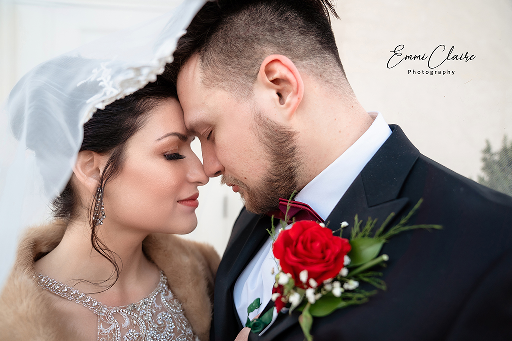 bride and groom touching foreheads with their eyes closed as they soak in the biggest day of their lives being celebrated at the Cathedral of the Sacred Heart