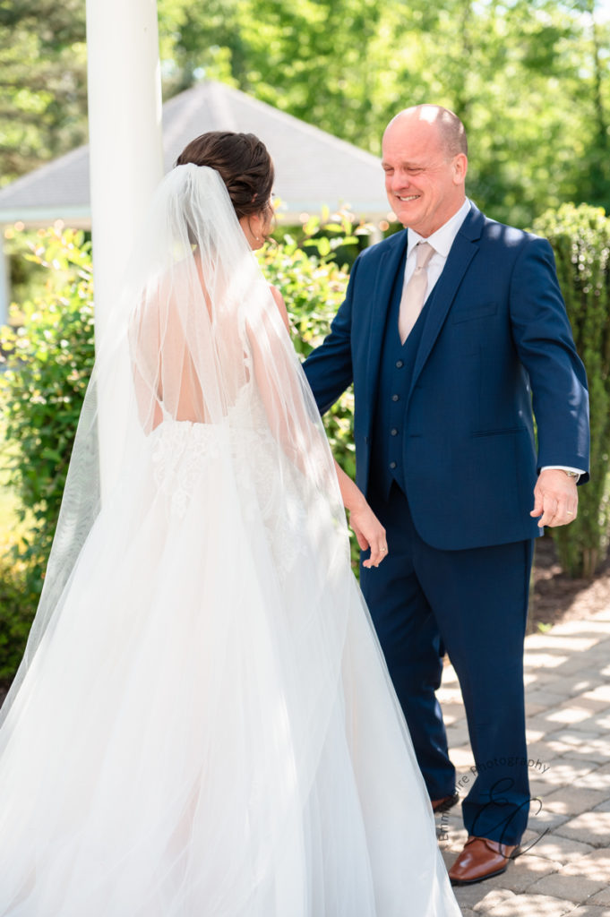 bride's father is brought to happy tears as he gets a first look at his daughter in her wedding dress