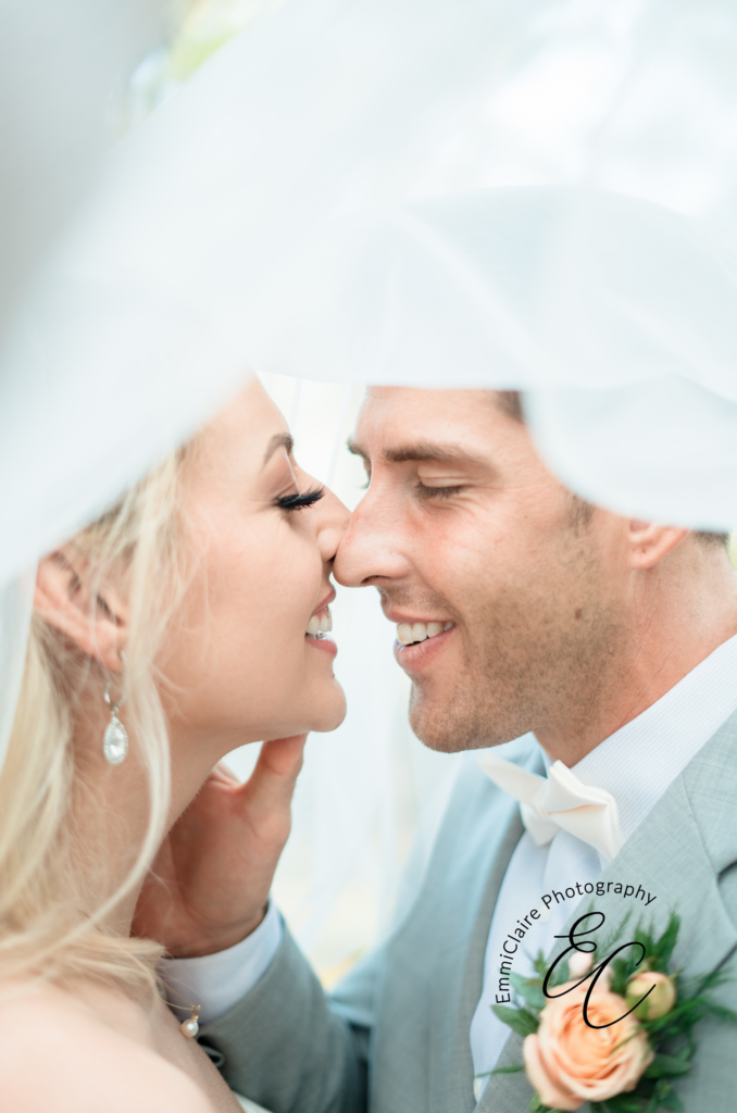bride and groom about to share an intimate kiss under her veil as captured by their dream wedding photographer