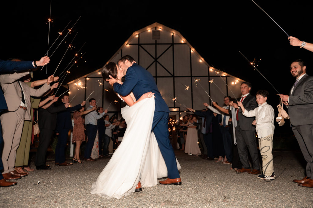 bride and groom share a kiss during the sparkler exit to their southern wedding reception