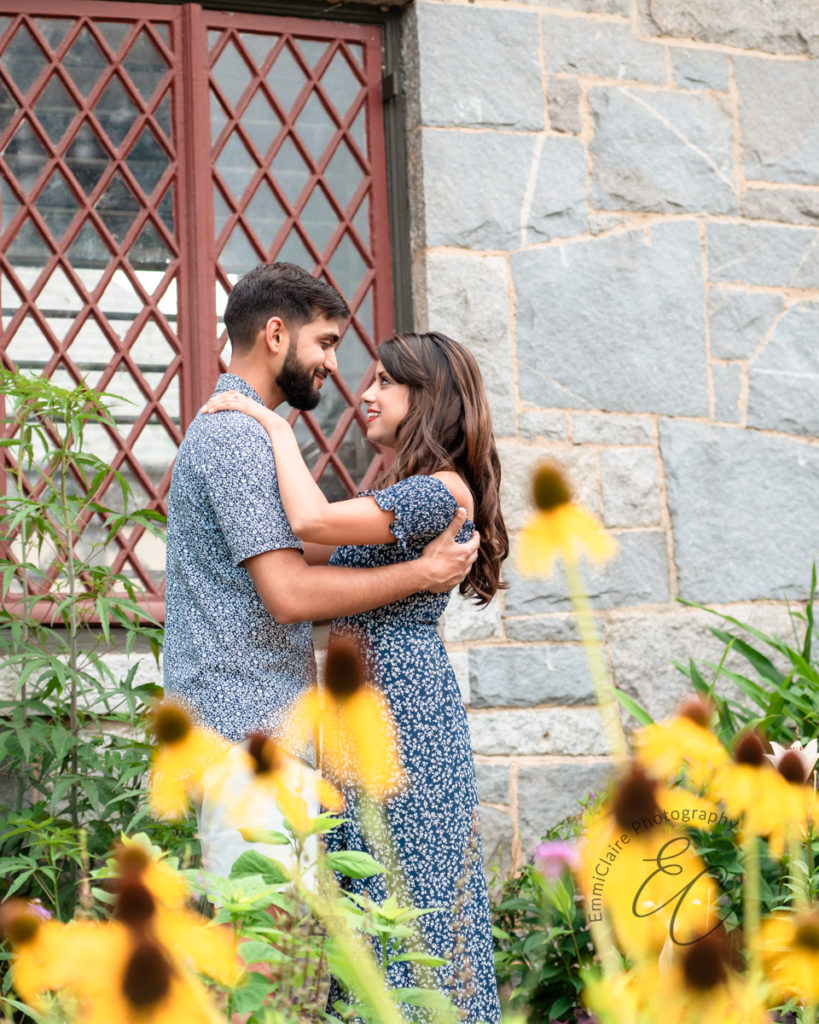 couple smiles and embraces while their love is captured in a photo during their engagement session