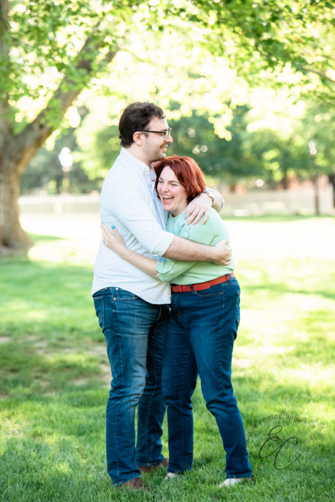 Couple hugs and laughs together during their outdoor engagement photoshoot at The College of William & Mary
