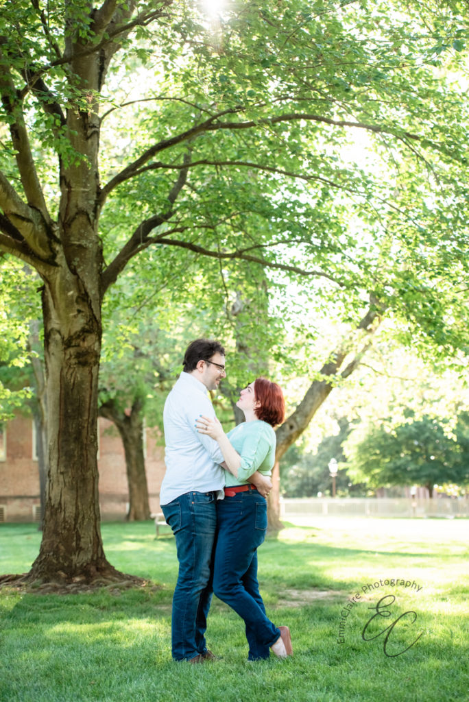 Couples holds one another close and stares into each other's eyes during their engagement session at The College of William & Mary.