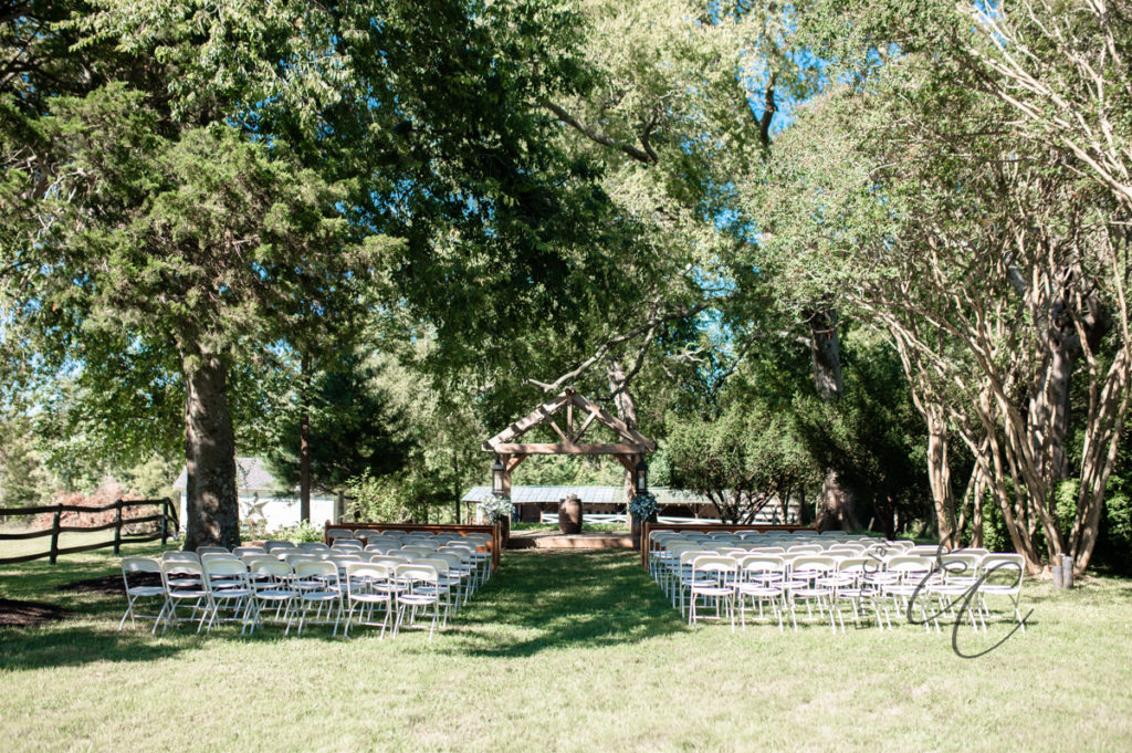 outdoor wedding ceremony setup for a pastoral wedding at Poplar Hill in Blackstone, Virginia with EmmiClaire Photography 