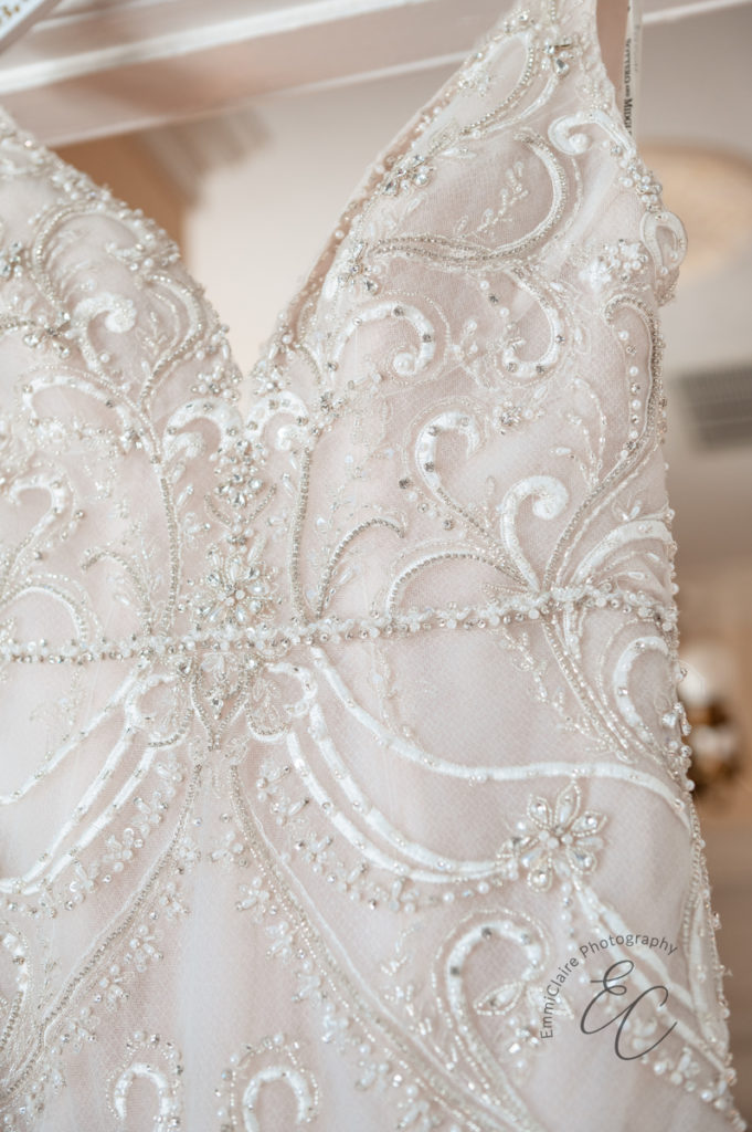 close up of the top of the bride's beaded and detailed wedding dress that she will be married in at Poplar Hill