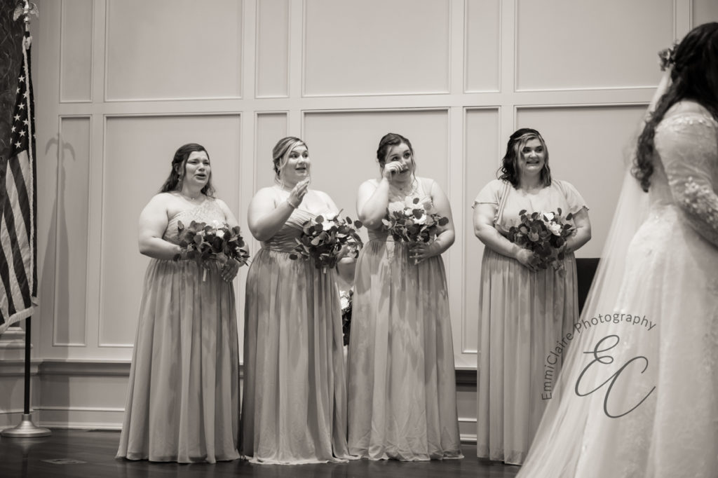 The bridesmaids tear up during the recitation of vows during the wedding ceremony.