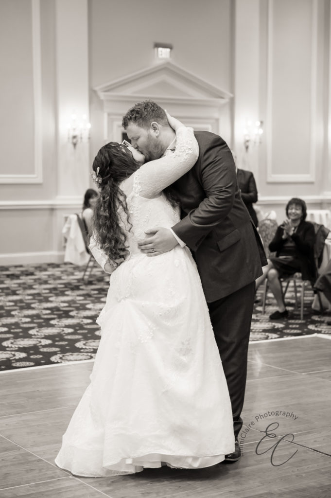 The bride and groom share a kiss during their first dance.