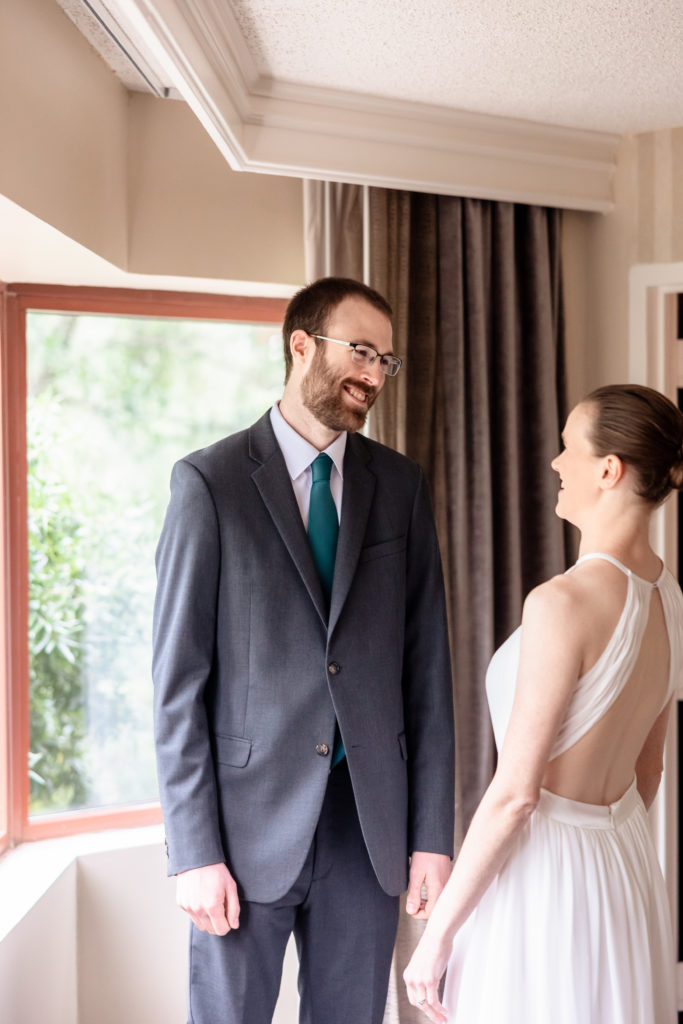 Sarah and hunter see each other for the first time before their atrium wedding ceremony in Charlottesville, VA