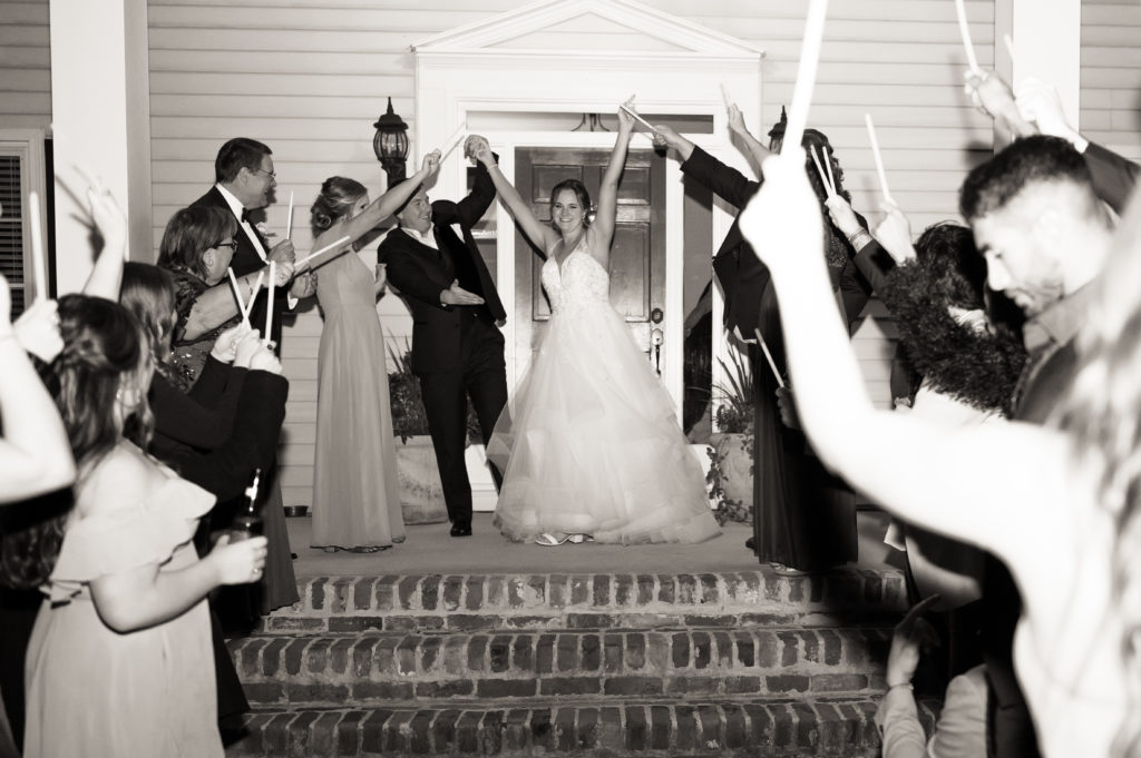 Bride and groom coming out of reception space before exiting wedding