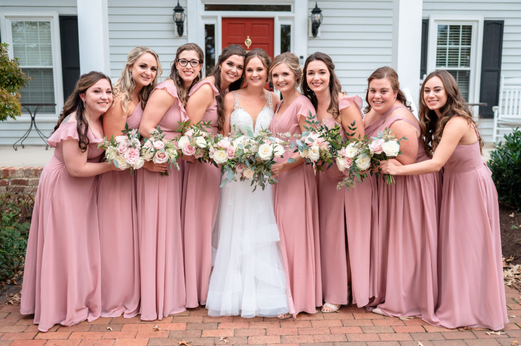 A group photo of the bridal party, with the bridesmaids