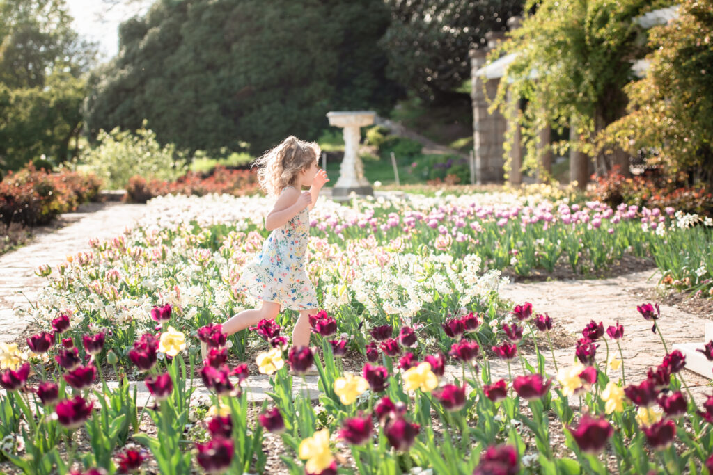 girl running through tulips