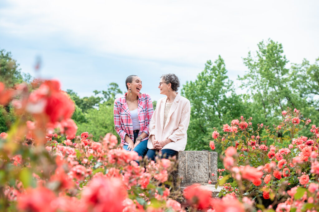 woman and her mother sitting down around roses
