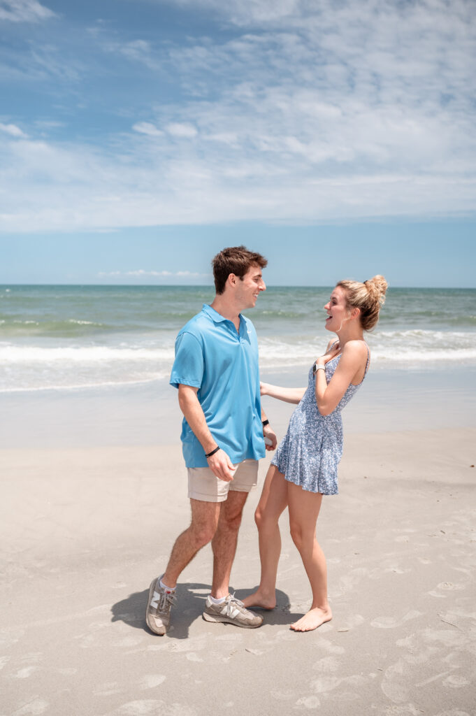 Logan and Chloe's Beach Proposal looking at each other