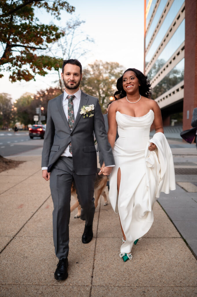 Newly married couple walking together during wedding portraits.