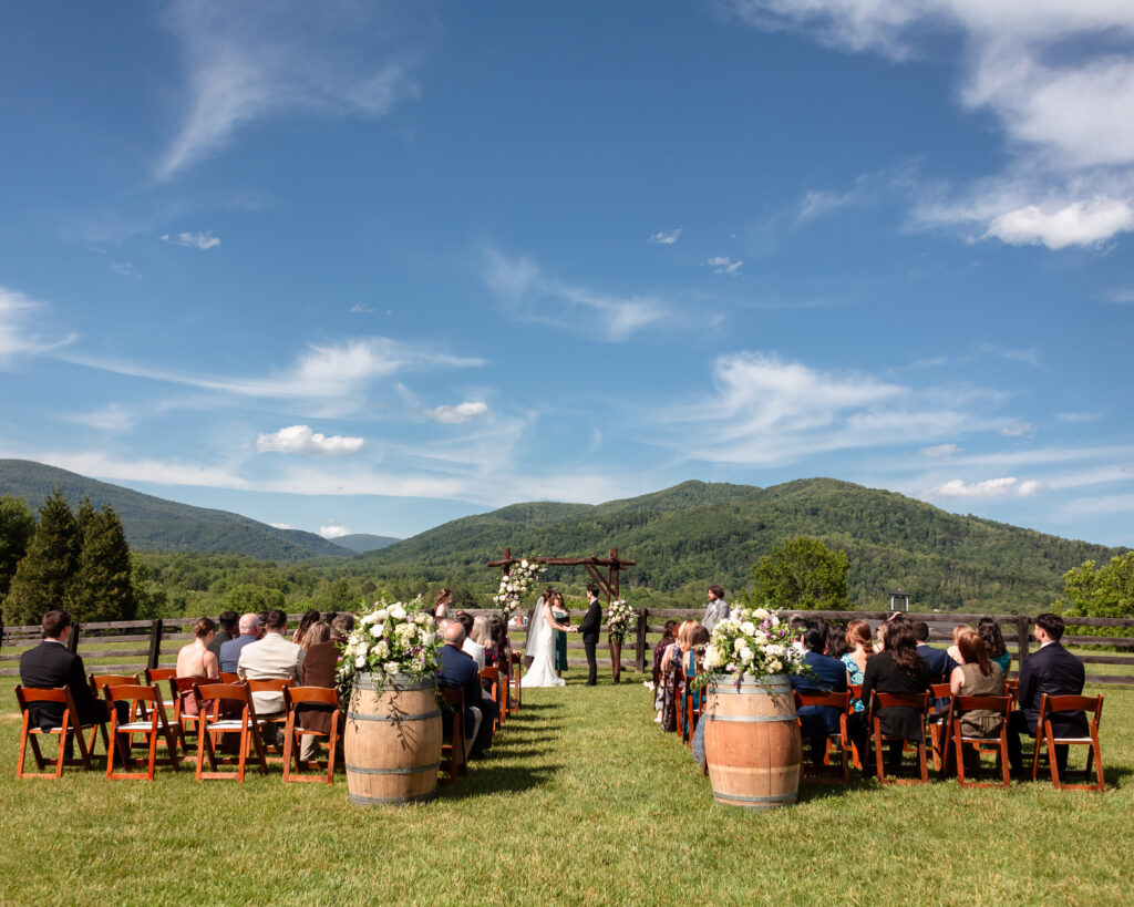 outdoor wedding ceremony at montfair resort farm with mountain backdrop