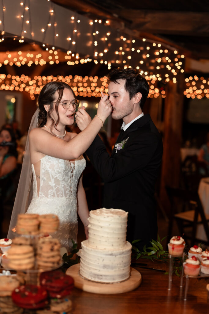 candid cake moment at crozet wedding reception