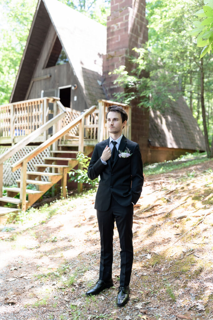 groom posing while getting ready at a-frame cabin, crozet virginia
