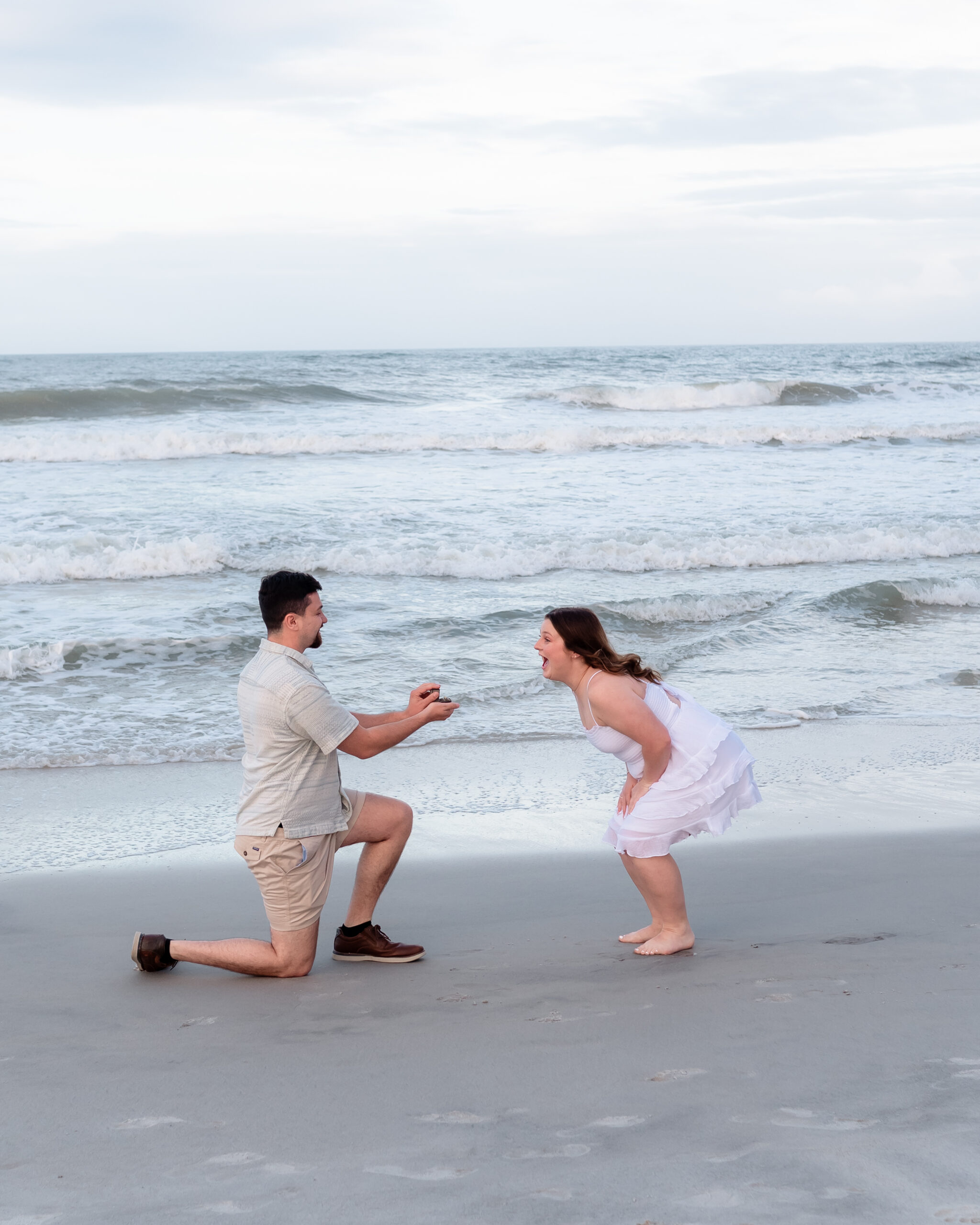 Surprise beach engagement captured by EmmiClaire Photography
