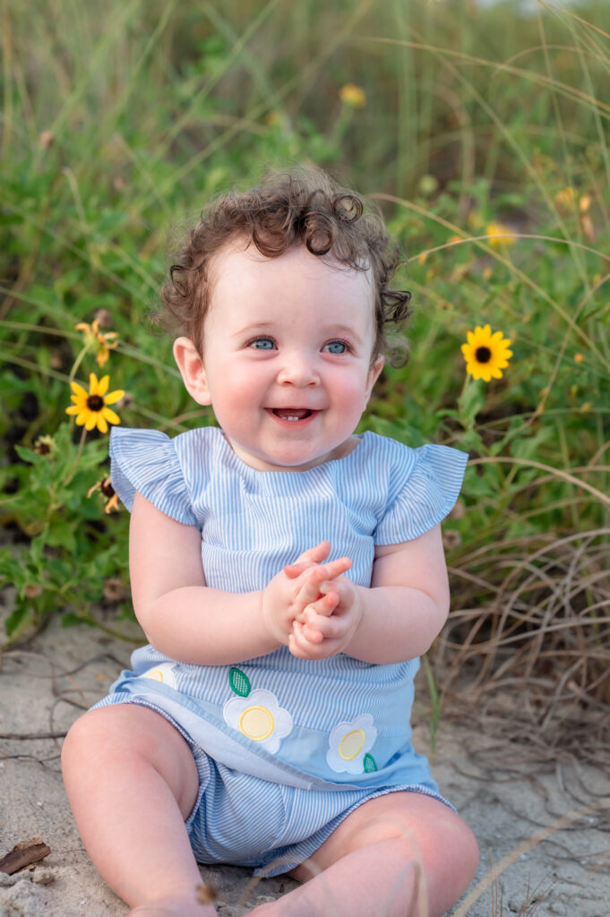 Youngest baby of the Denning family smiling in the dunes at Omni Amelia Island Resort during sunset.