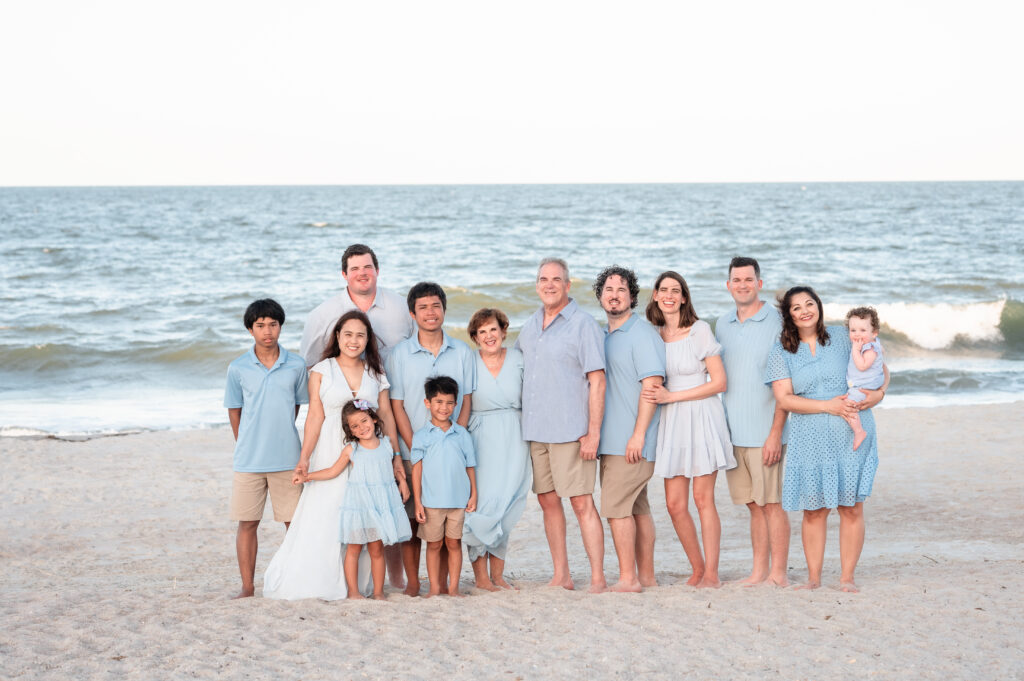 Grandparents standing with their children and grandchildren for a multi-generational family portrait on Amelia Island.