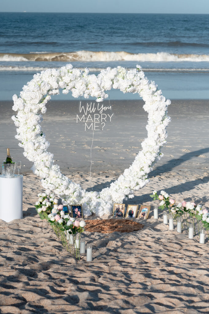 Romantic oceanfront floral arch setup at Ponte Vedra Beach proposal photography.