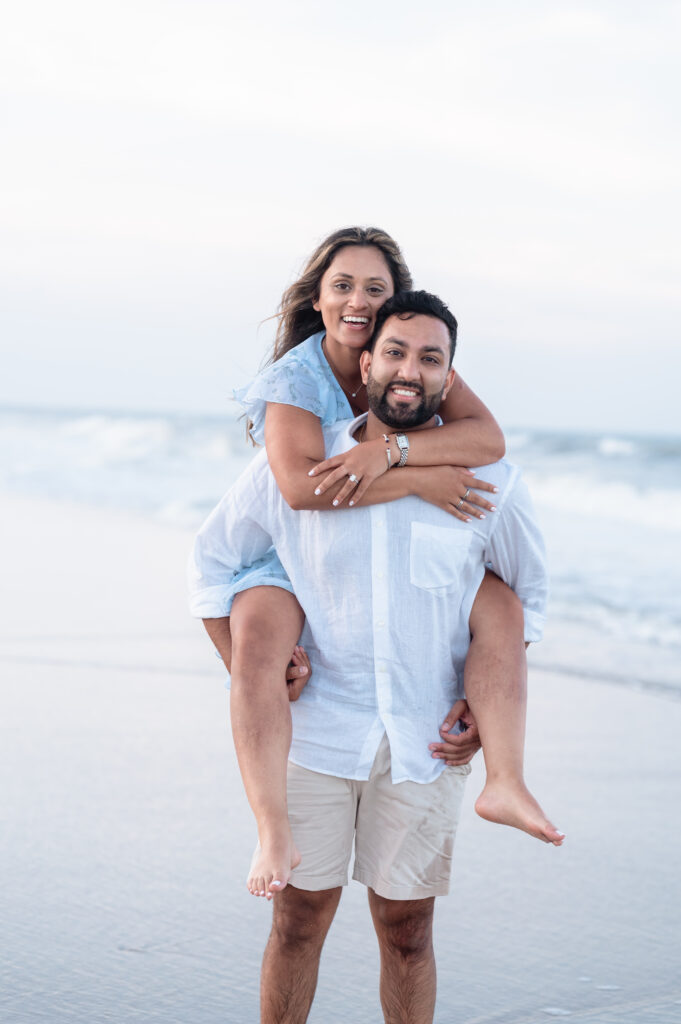 Sahil and Pooja laughing during candid Ponte Vedra Beach proposal photography.