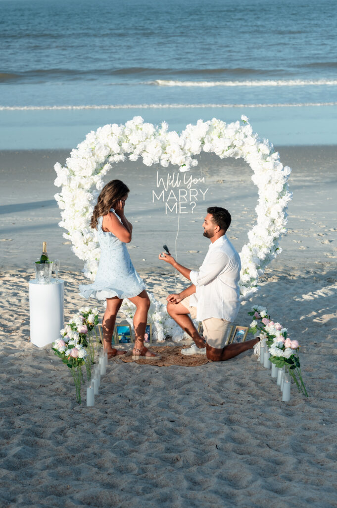 Pooja smiling as Sahil proposes at Ponte Vedra Beach with romantic setup.