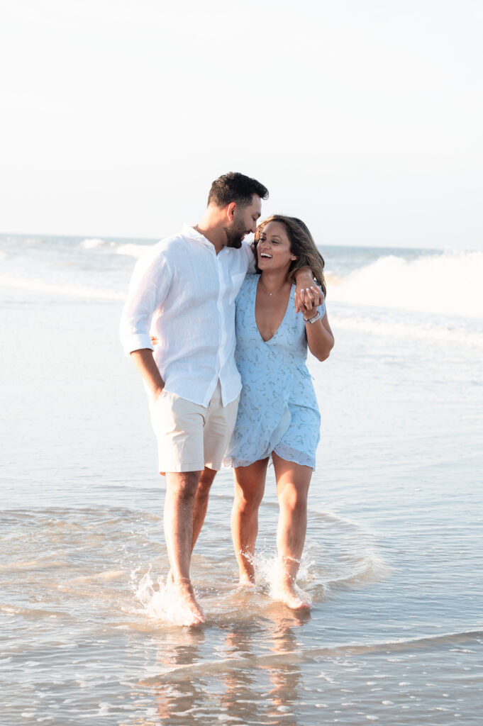 Couple walking along shoreline after Ponte Vedra Beach proposal photography.
