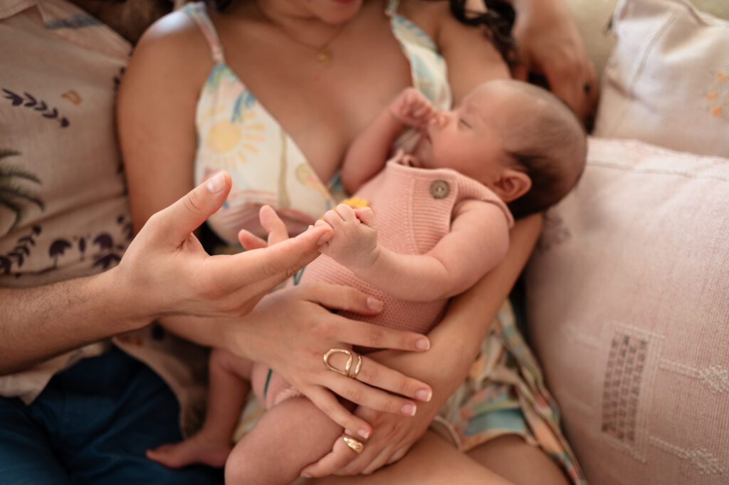 first-time parents cuddling newborn during lifestyle session