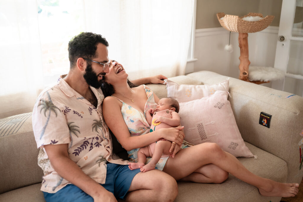 wide shot of family with newborn in living room in jacksonville home