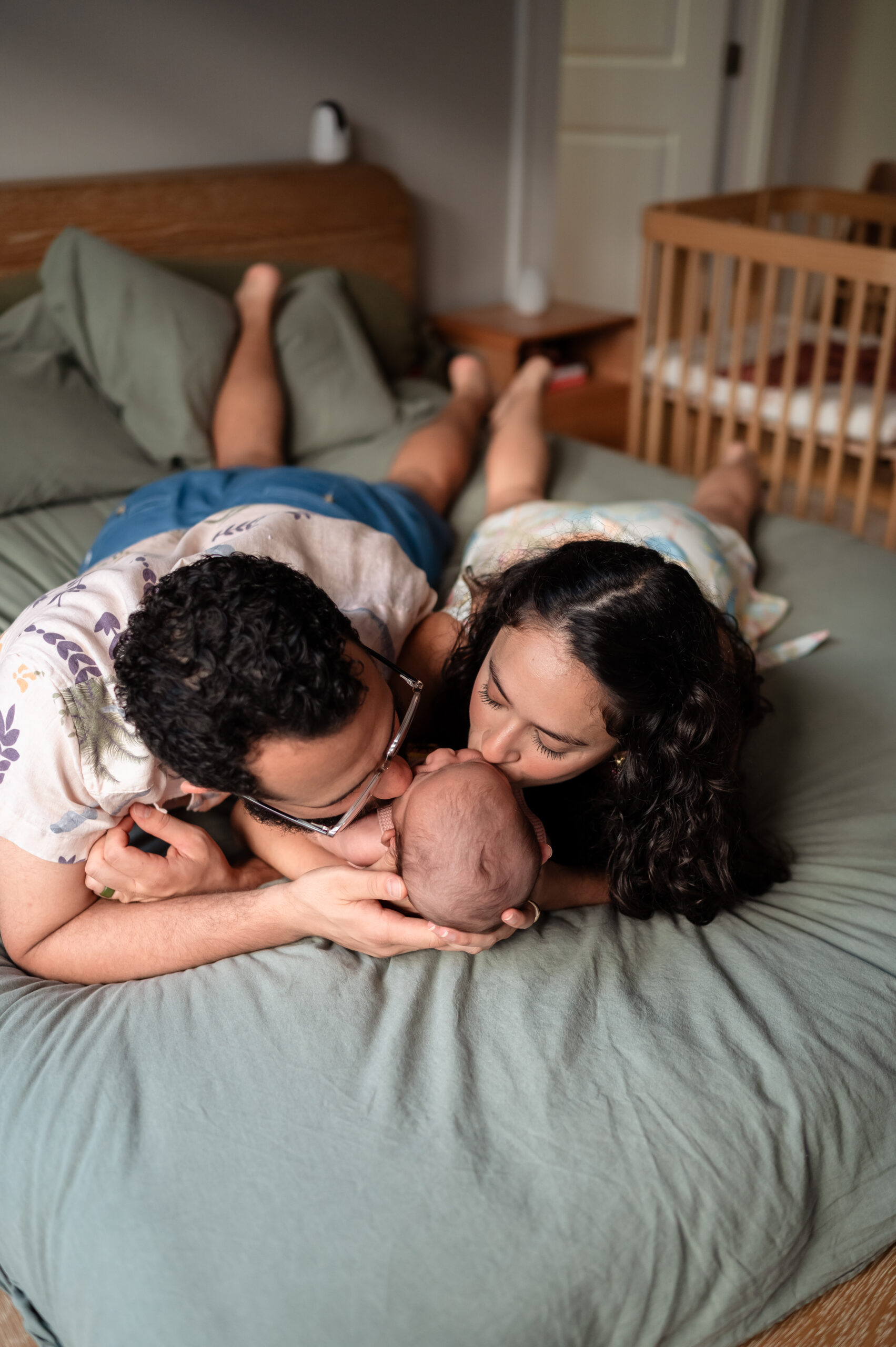 parents holding newborn baby salma during in-home lifestyle session in jacksonville