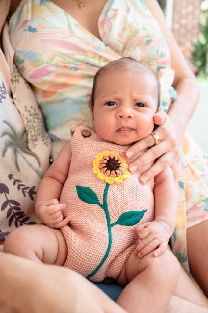 close-up of newborn baby girl swaddled in natural window light