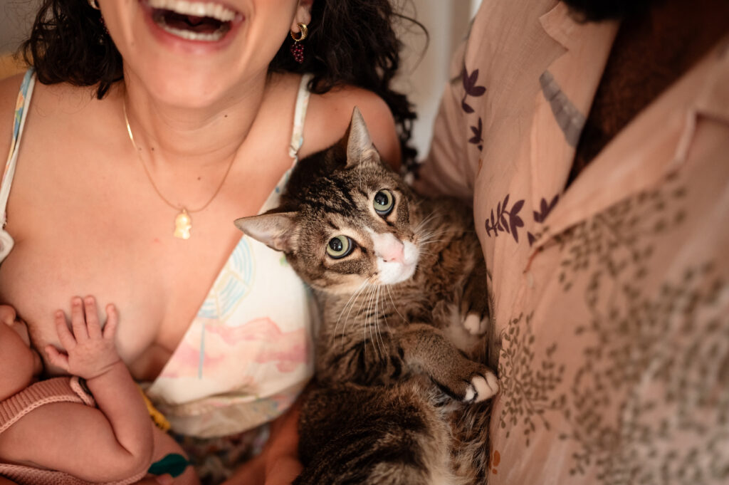 mother breastfeeding newborn baby salma during in-home session