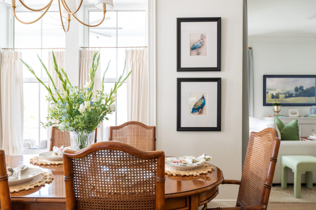 Bright white dining room interior with bird artwork and neutral accents.