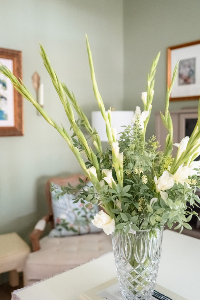 Branding photoshoot of office interior with floral desk skirt and framed artwork.