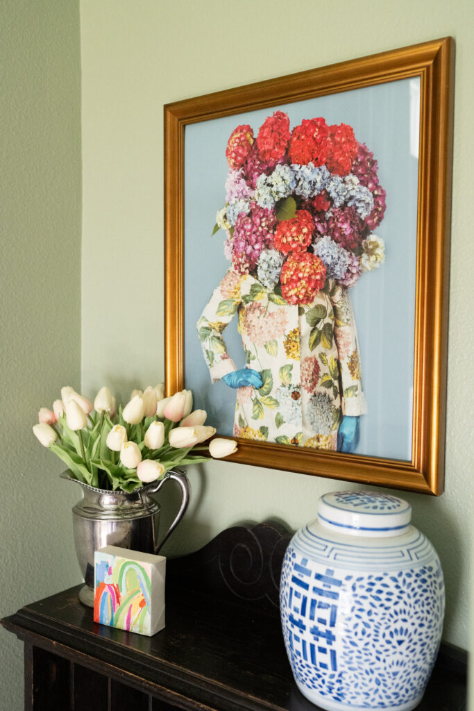 Home office with sage green walls and natural light during branding photography session.