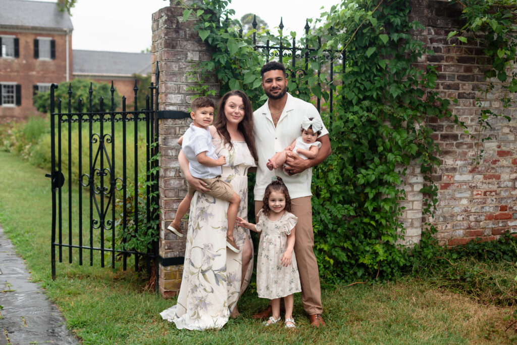 Family of five walking toward camera at Chatham Manor