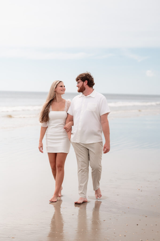 Kristen’s white dress blowing slightly in the wind during beach photos.