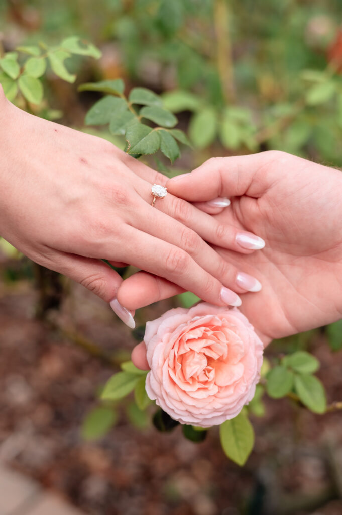 Close-up of the engagement ring as Brandon holds Kristen’s hand.
