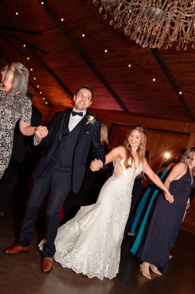 Reception details inside the barn with warm lighting and elegant wedding decor