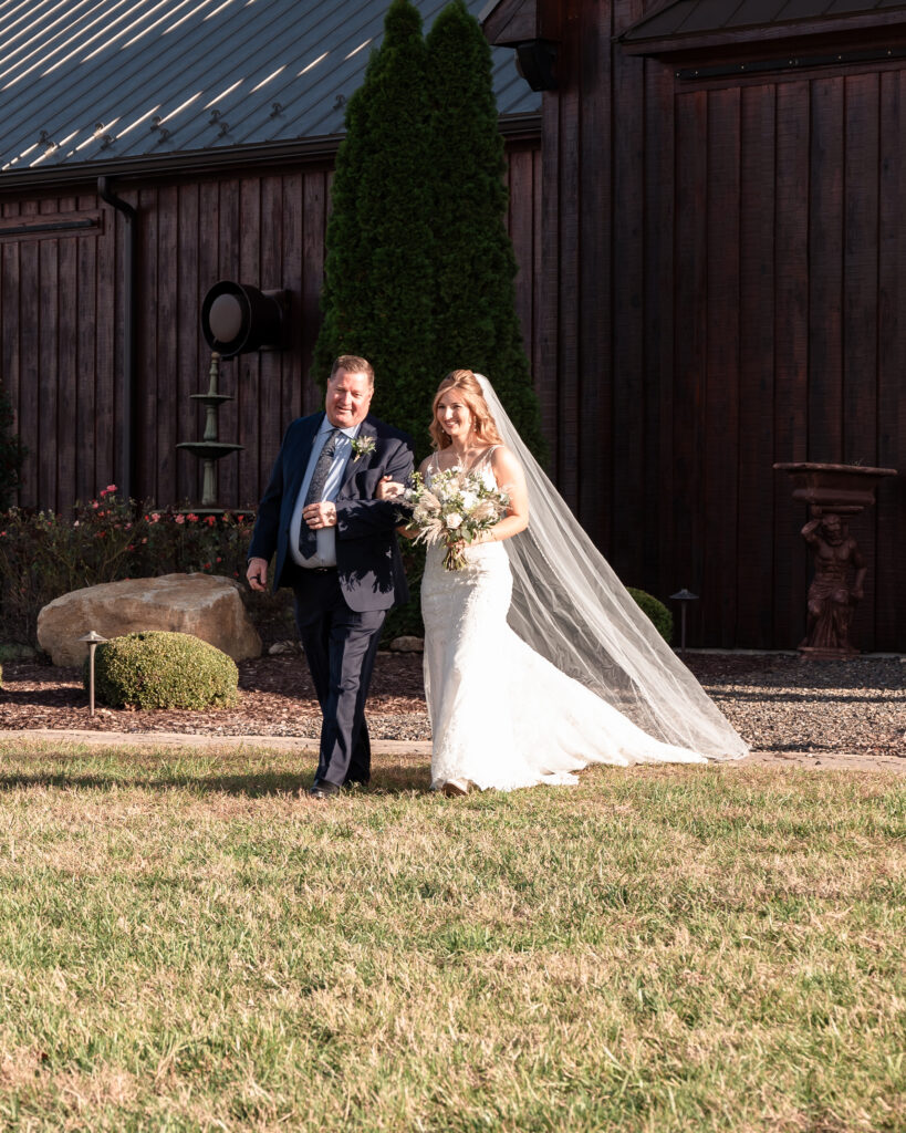 Bride walking down the aisle at Atkinson Farms during a dreamy Virginia fall wedding