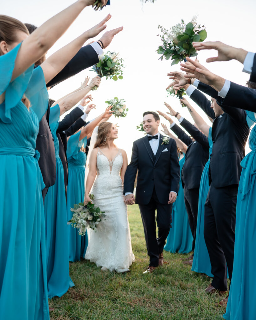 Wedding party group photo with bridesmaids and groomsmen in navy and ivory tones