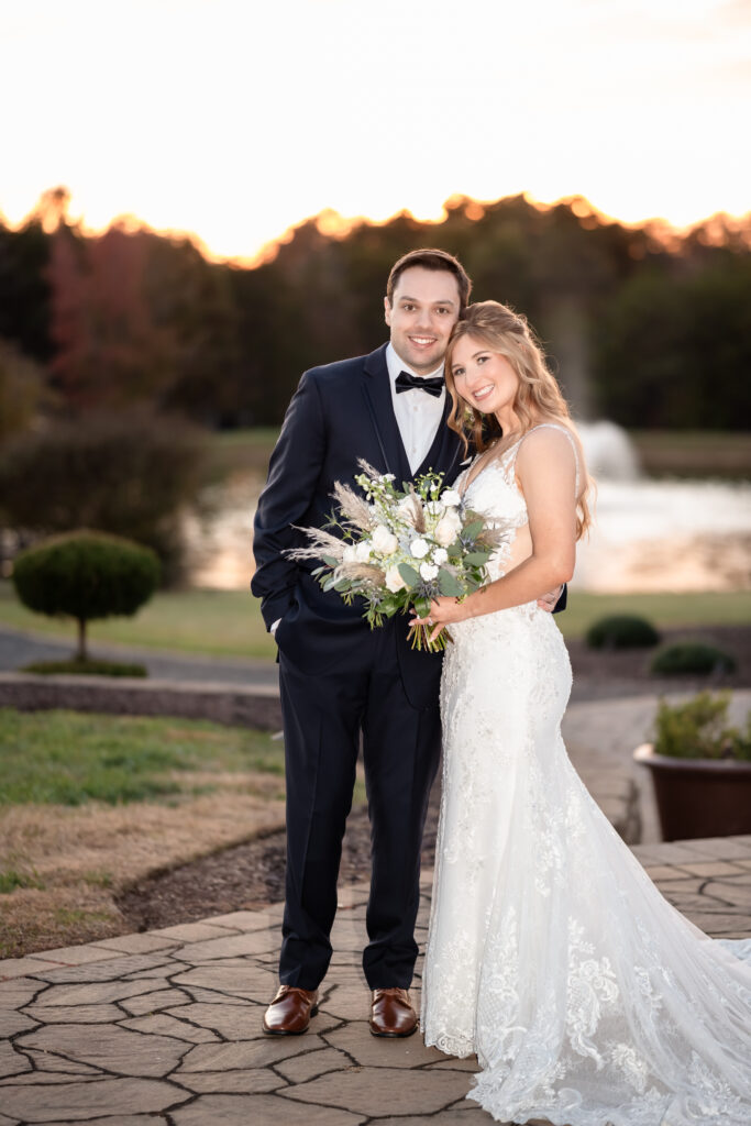 Bride and groom smiling together during fall wedding portraits captured by EmmiClaire Photography