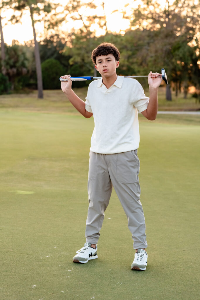 Kids practicing putting on the green during lifestyle family session in Jacksonville