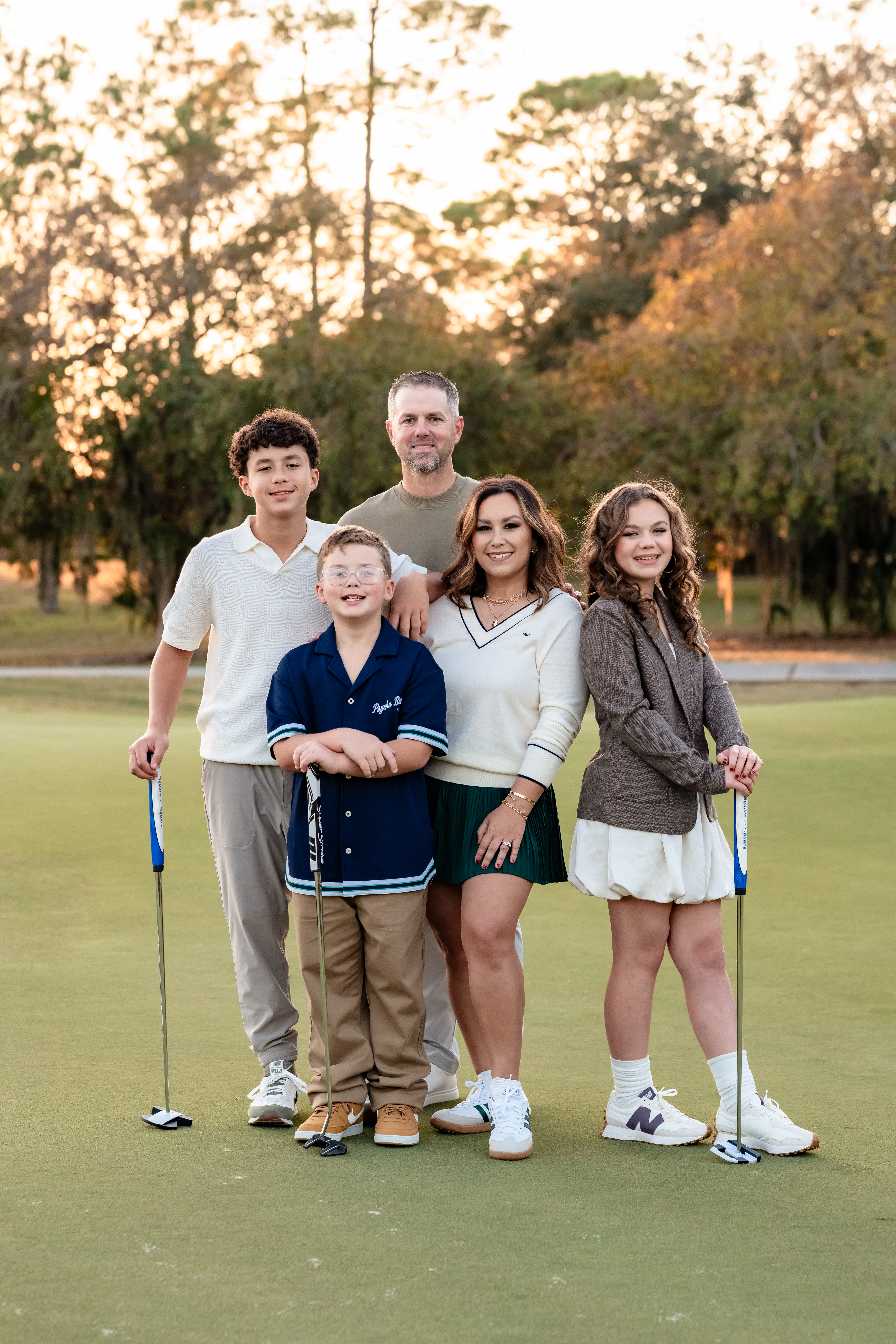 Baldwin family posing together with golf clubs at Deerwood Country Club in Jacksonville Florida