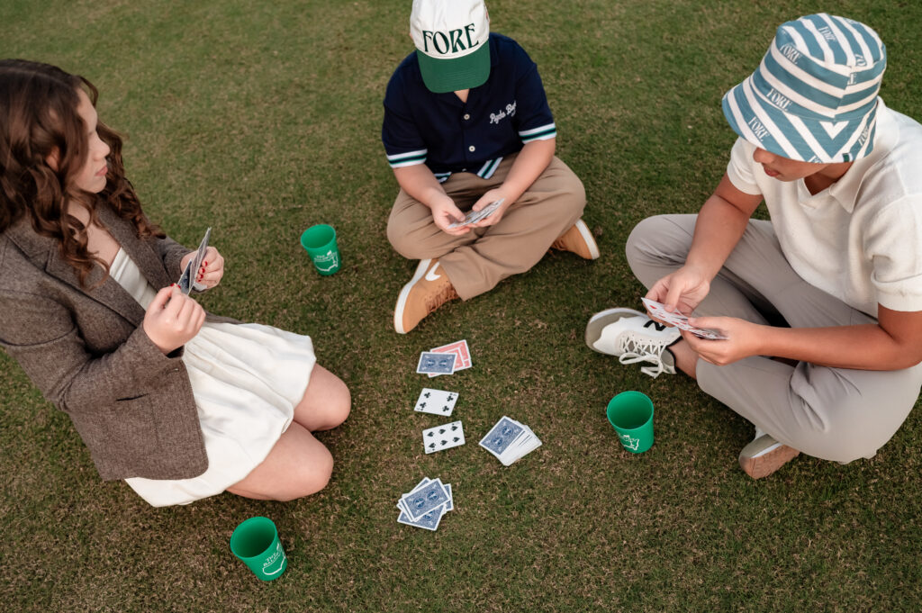 Baldwin family sitting on the green with custom cups during creative Jacksonville family session
