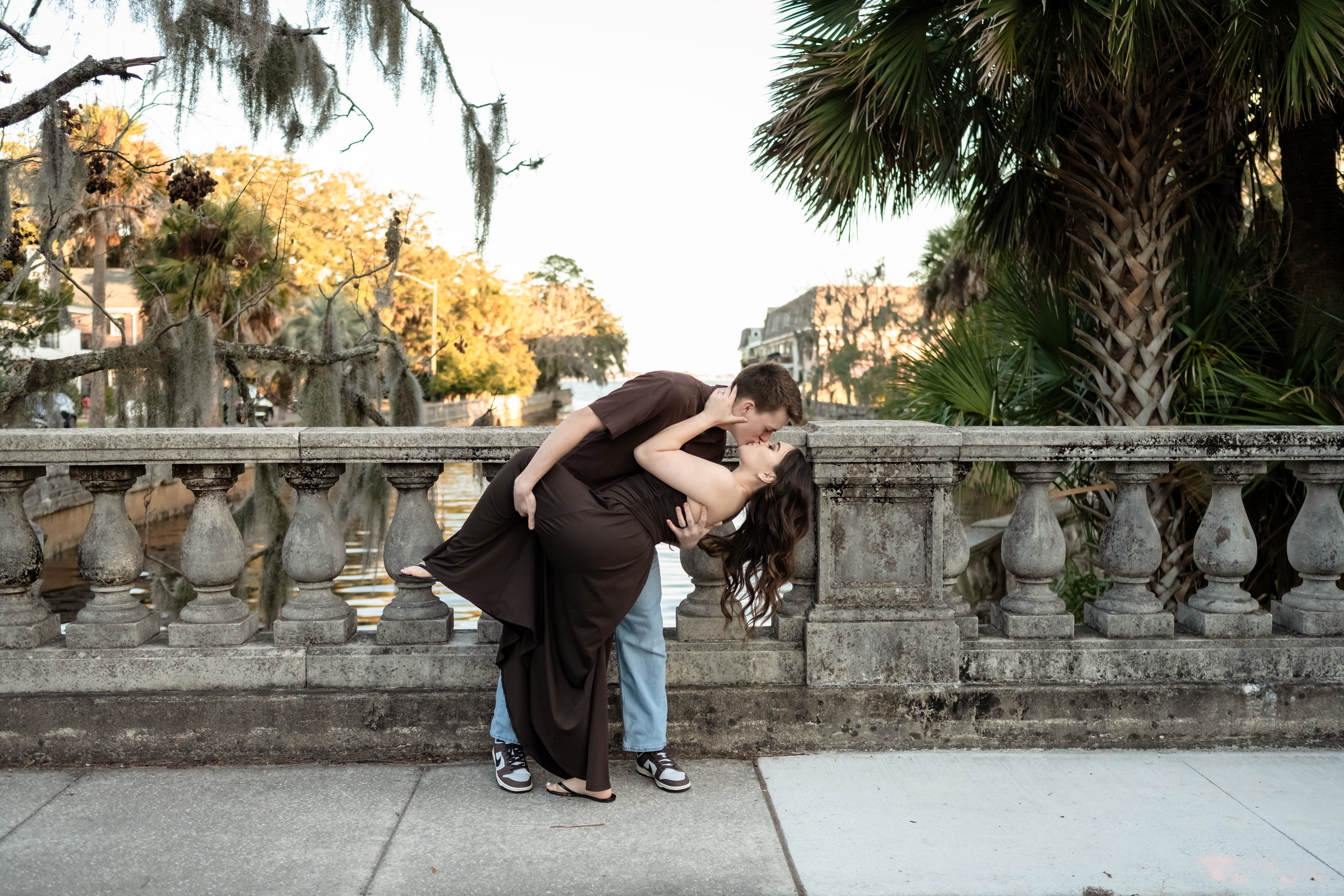 Groom lifting bride under Spanish moss during Jacksonville engagement session