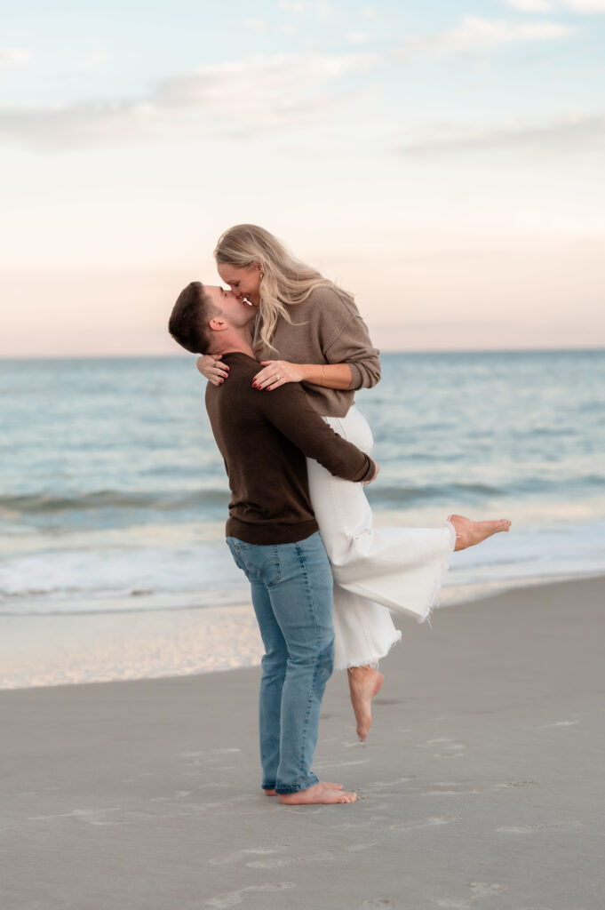 Rachel and Chase sharing a romantic moment along the shoreline after getting engaged.